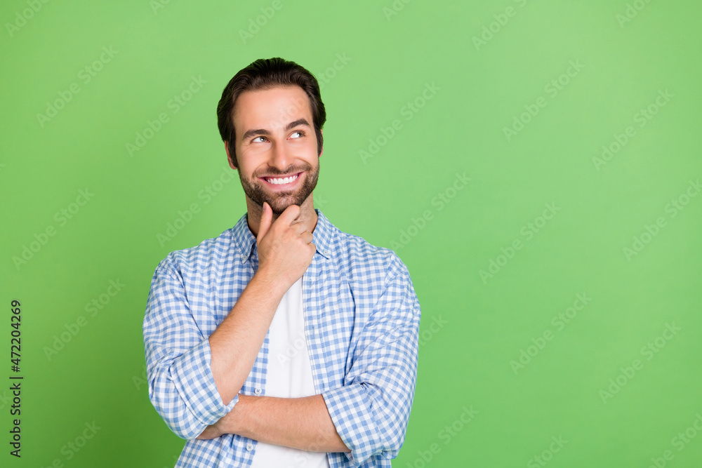 Photo of hr millennial guy look empty space wear checkered shirt isolated on green color background Photo of hr millennial guy look empty space wear checkered shirt isolated on green color background