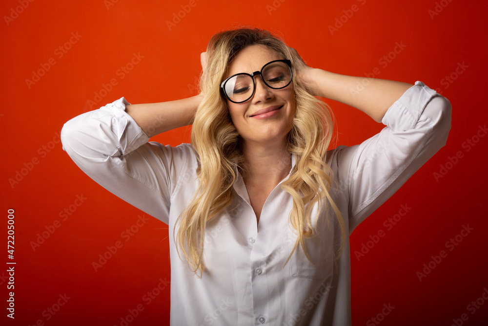 portrait of a happy adult female wearing glasses on a red background portrait of a happy adult female wearing glasses on a red background