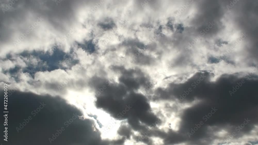 Gray clouds floating in time laps with sunbeam in the sky Gray clouds floating in time laps with sunbeam in the sky