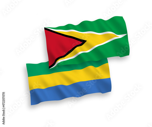 National vector fabric wave flags of Co-operative Republic of Guyana and Gabon isolated on white background. 1 to 2 proportion.