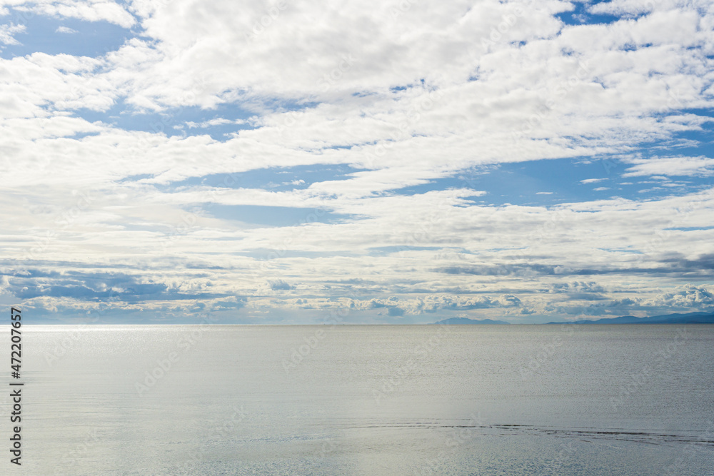 view to the Strait of Georgia from Iona Beach Regional Park azure water cloudy blue sky view to the Strait of Georgia from Iona Beach Regional Park azure water cloudy blue sky