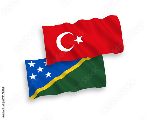 National vector fabric wave flags of Turkey and Solomon Islands isolated on white background. 1 to 2 proportion.