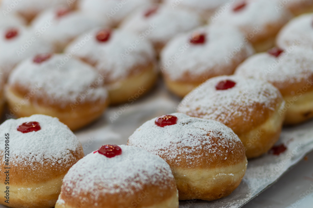 fried and stuffed sufganiot with strawberry jam, displayed for sale at the Mahane Yehuda market in Jerusalem, Hanukkah fried and stuffed sufganiot with strawberry jam, displayed for sale at the Mahane Yehuda market in Jerusalem, Hanukkah