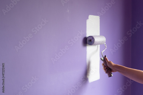 Painting at home with hand roller and copy space