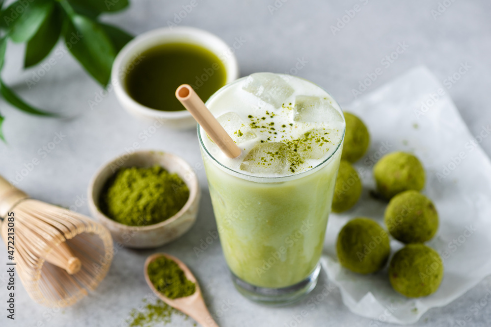 Ice latte Matcha tea in glass served with raw energy balls. Vegan food Ice latte Matcha tea in glass served with raw energy balls. Vegan food