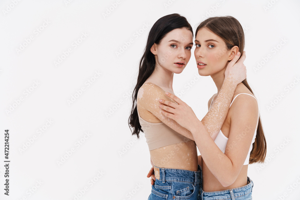 Two young woman in underwear standing together Two young woman in underwear standing together
