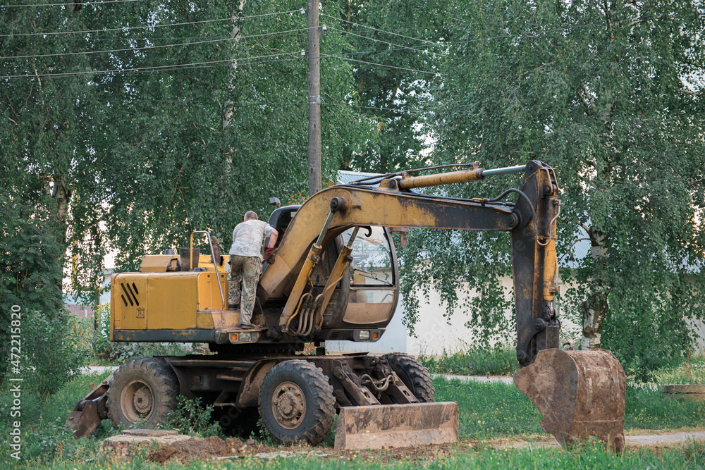 the excavator driver climbs into the cab the excavator driver climbs into the cab