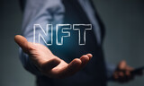 Smartphone with NFT logo in man hand.