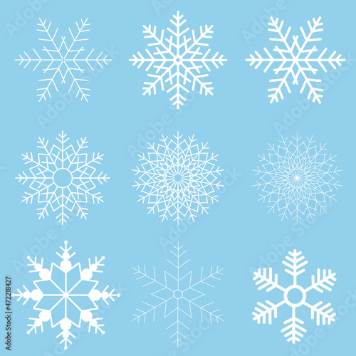 Winter set of white snowflakes isolated on light blue background. Snowflake icons. Snowflakes collection for design Christmas and New Year banner and cards.