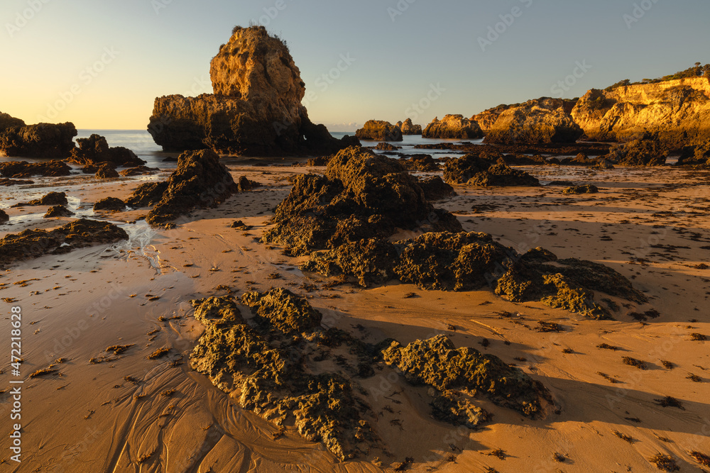 Beach rocks with golden light in Praia De Boiao (Algarve, Portugal)
