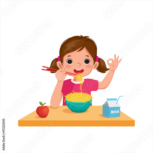 Cute little girl eating delicious noodles using chopsticks showing okay sign gestures.

