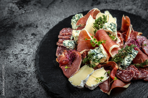 Fotografija board with different kinds of cheese and ham, prosciutto, jamon salami, Antipast