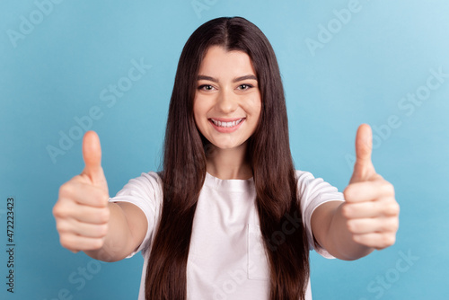 Photo of young cheerful lady show thumb-up advertising perfect great isolated over blue color background © Tetiana