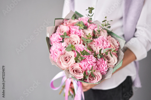 Fototapeta Naklejka Na Ścianę i Meble -  Beautiful large bouquet of mixed flowers without packaging. Handsome fresh bouquet in woman hand. Small flower shop and Flowers delivery.