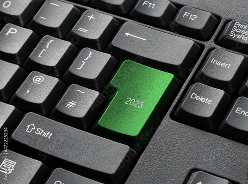 A Black Keyboard With green 2023 key