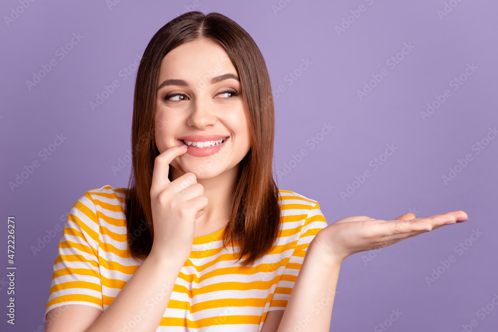 Photo of young cheerful girl finger touch chin curious dream product promotion isolated over violet color background Photo of young cheerful girl finger touch chin curious dream product promotion isolated over violet color background