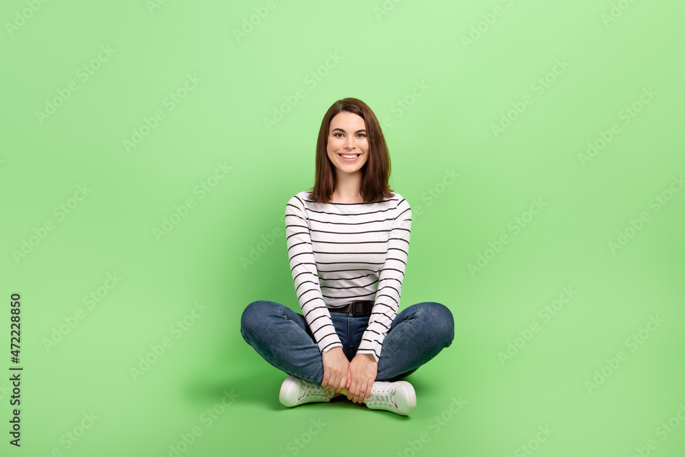 Full size photo of young lovely girl sitting floor rest dream wear casual clothes isolated over green color background Full size photo of young lovely girl sitting floor rest dream wear casual clothes isolated over green color background
