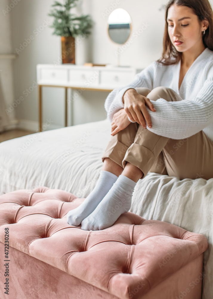 Interior, a girl in a bright room, upholstered furniture in the room, natural light, calm colors Interior, a girl in a bright room, upholstered furniture in the room, natural light, calm colors
