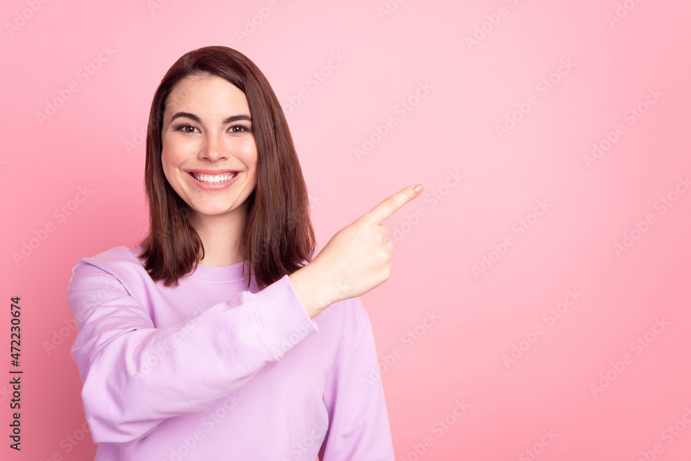 Photo of young cheerful girl inidctae ifnger empty space promo ad choice way isolated over pink color background Photo of young cheerful girl inidctae ifnger empty space promo ad choice way isolated over pink color background