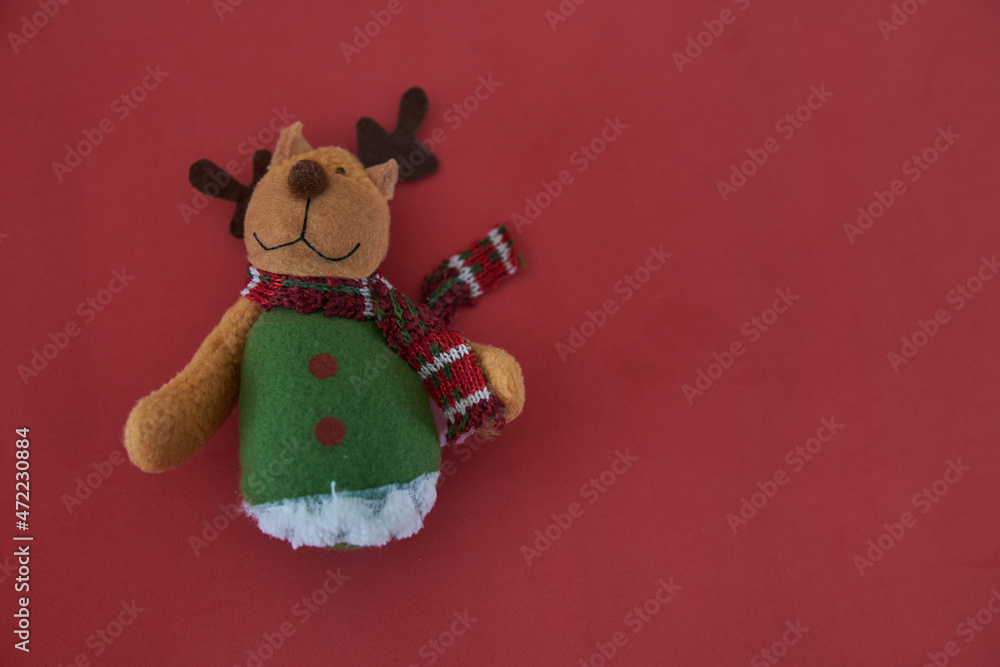 Cute reindeer christmas ornament on a red background. Horizontal postcard. Copy space Cute reindeer christmas ornament on a red background. Horizontal postcard. Copy space