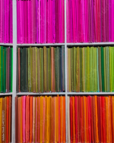 Rolls of fabric and textiles in shop. Multi colors indian patterns on the market Fabrics in rolls. Fabric store in Pune, Maharashtra, India.
