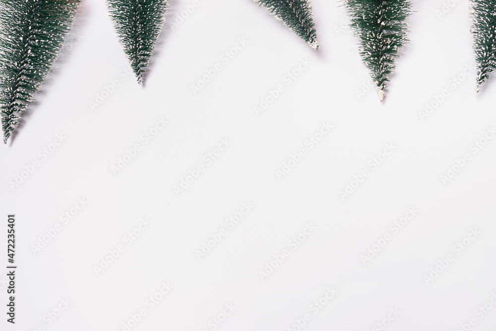 frame from small decorated christmas trees on white background with copy space frame from small decorated christmas trees on white background with copy space