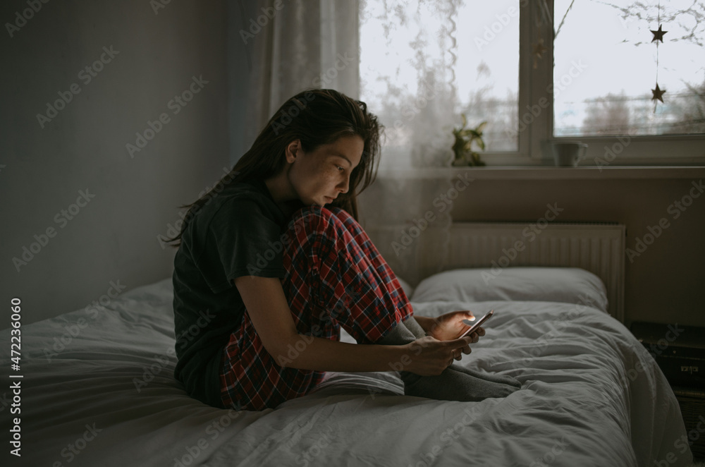 young woman with the mobile at home young woman with the mobile at home