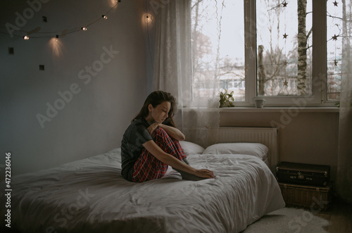 young woman with the mobile at home