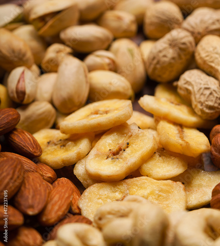 cashew nuts, hazelnuts, peanuts, banana, almonds close-up