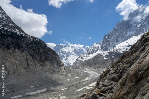 A view of the mountain peaks and clouds at the Mer de Glace in Chamonix, France on a sunny summer day in the French Alps