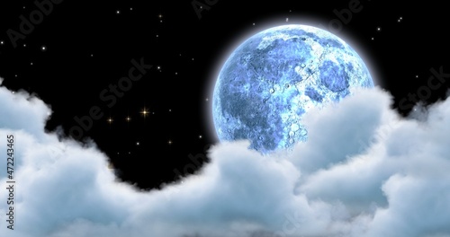 Digital composite of moon in clouds and star field at night with copy space