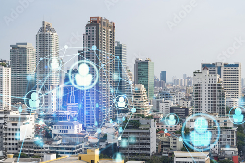 Social media icons hologram over panorama city view of Bangkok, Southeast Asia. The concept of people networking, connections and career opportunities. Double exposure.