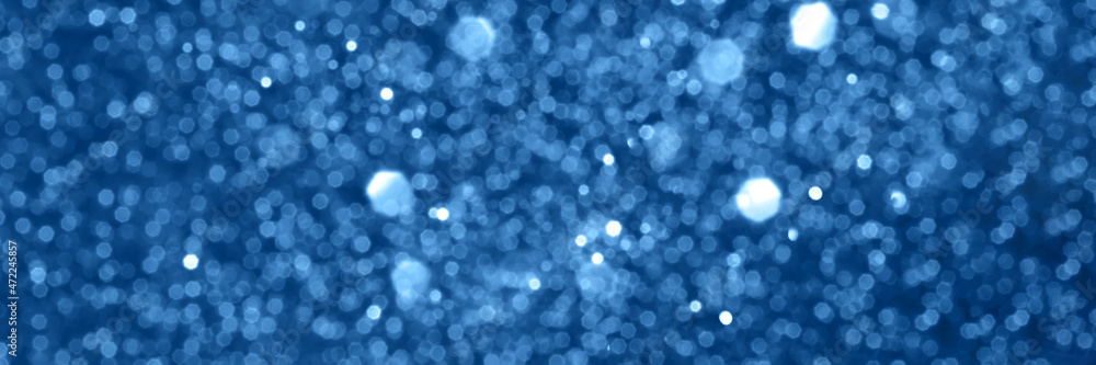 Blue sparkling glitter bokeh background, christmas texture. Holiday lights. Abstract defocused header. Wide screen wallpaper. Panoramic web banner with copy space for design Blue sparkling glitter bokeh background, christmas texture. Holiday lights. Abstract defocused header. Wide screen wallpaper. Panoramic web banner with copy space for design