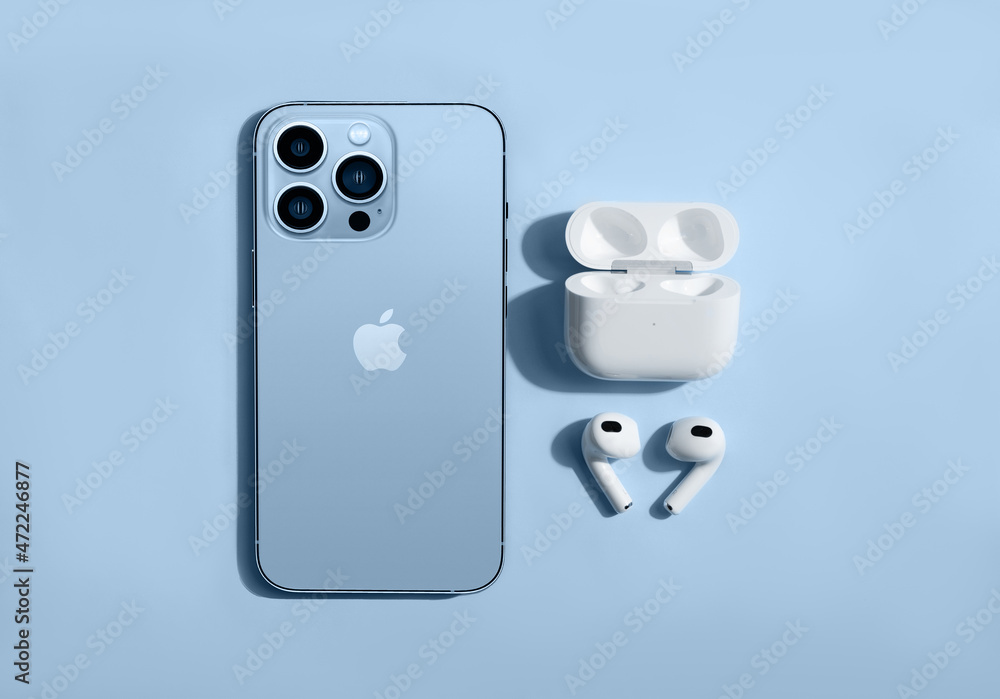 Foto Stock New apple AirPods 3 with iPhone 13 pro on white background |  Adobe Stock