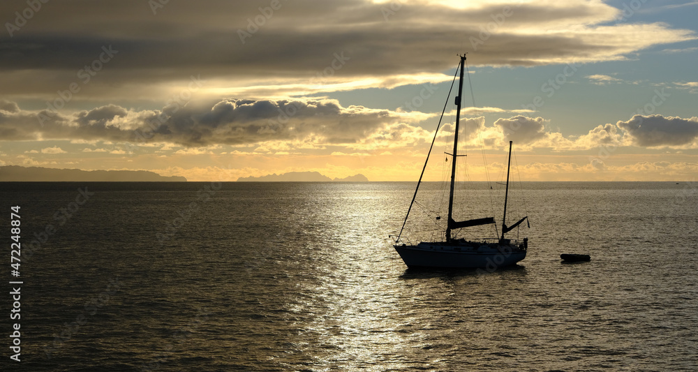 Sailing boat silhoutte at dawn, Funchal, Madeira Island, Portugal