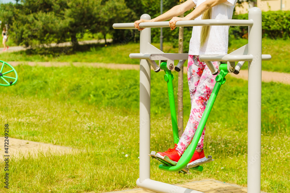 Fototapeta premium Woman doing exercise in outdoor gym