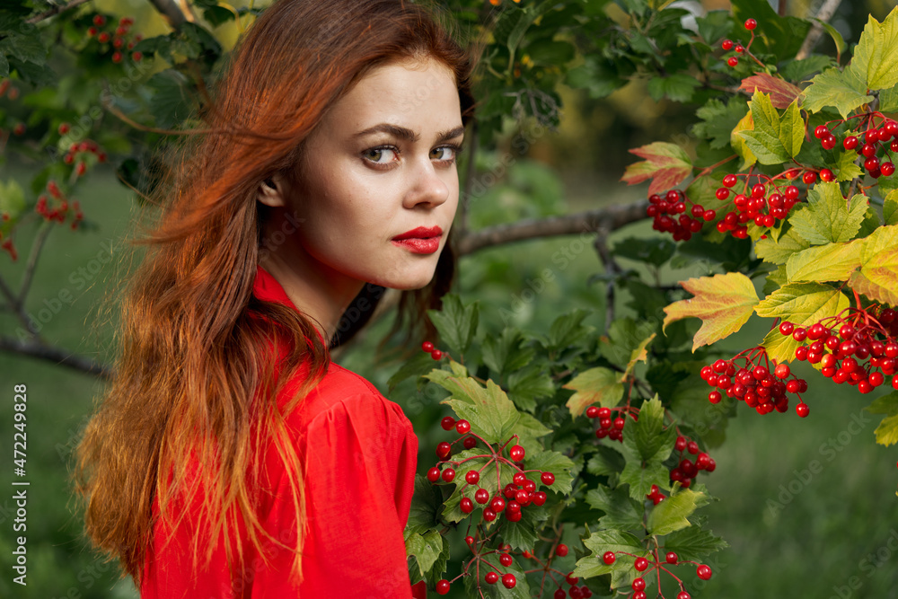 Naklejka premium Woman in red shirt plants berries nature summer
