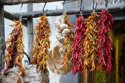 Italian Street Market; A display of fresh harvested, brightly colored Chili Peppers and Garlic Cloves on a street market cart in Sorrento, Italy