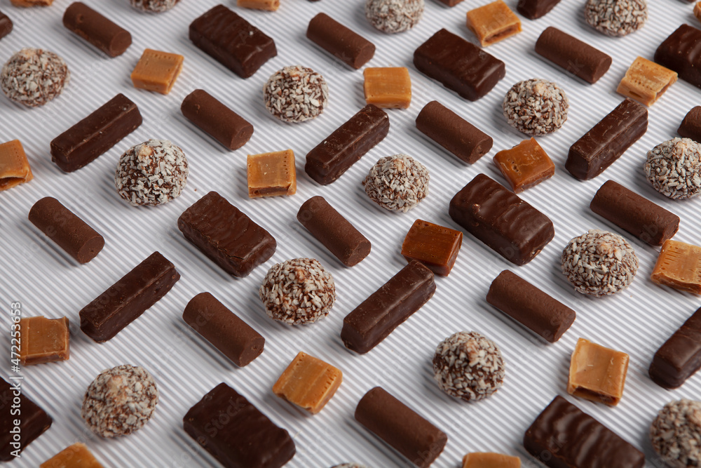 Festive Happy New Year's table full of chocolates. Assortment of delicious chocolate candies background Festive Happy New Year's table full of chocolates. Assortment of delicious chocolate candies background