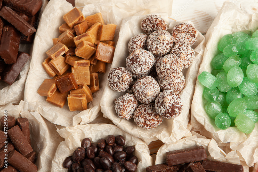 Festive Happy New Year's table full of chocolates. Assortment of delicious chocolate candies background