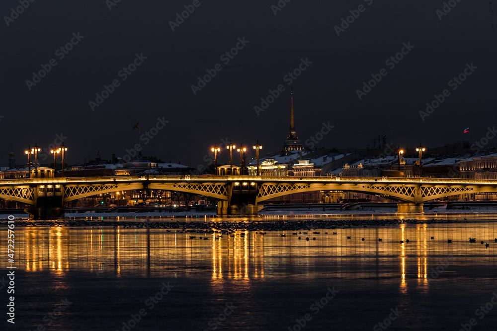 The panoramic footage of the winter night city Saint-Petersburg with picturesque reflection on water, Isaac cathedral on background, Blagoveshchensky bridge, old name is the lieutenant Schmidt