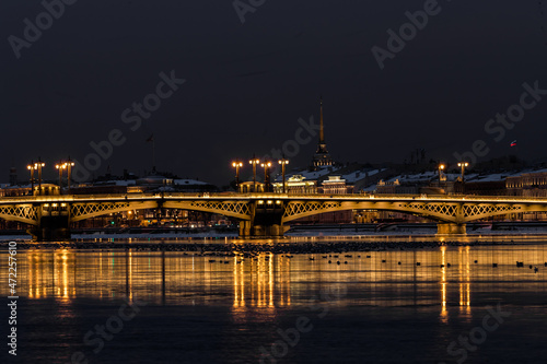 The panoramic footage of the winter night city Saint-Petersburg with picturesque reflection on water  Isaac cathedral on background  Blagoveshchensky bridge  old name is the lieutenant Schmidt