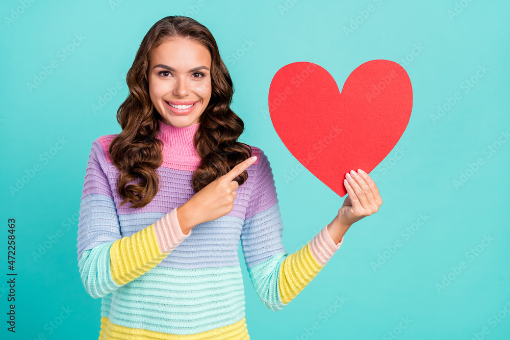 Photo of nice brunette millennial lady point heart wear striped sweater isolated on turquoise color background Photo of nice brunette millennial lady point heart wear striped sweater isolated on turquoise color background