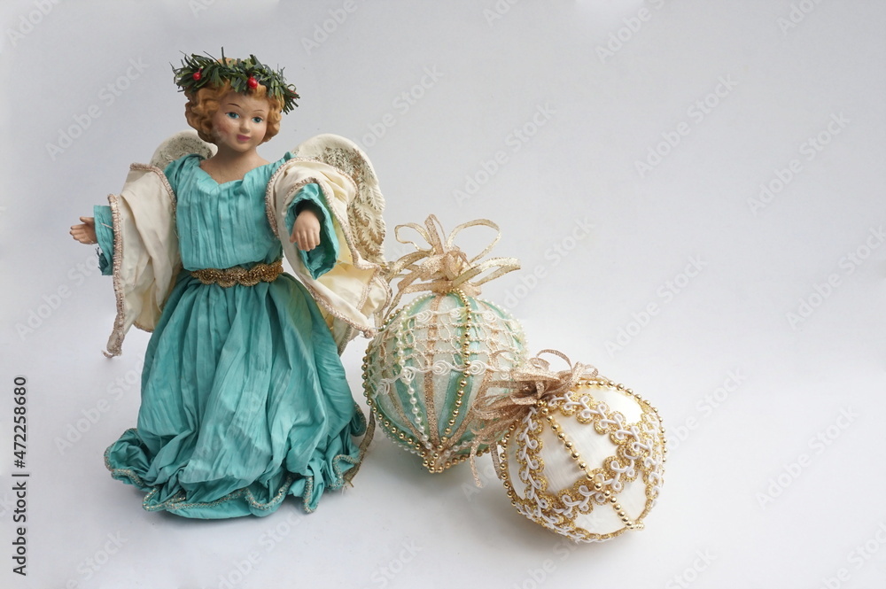 White Angel in Aqua Robes and Halo with Two Aqua Gold and Cream Colored Christmas Balls on White Background