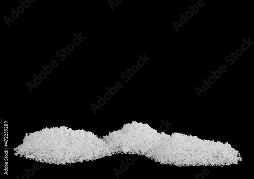A pile of white snow isolated on a black background.