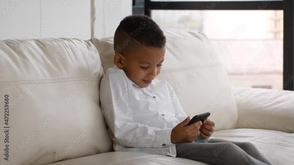 Excited Black Preteen Boy Playing Video Games On Smartphone At Home Excited Black Preteen Boy Playing Video Games On Smartphone At Home