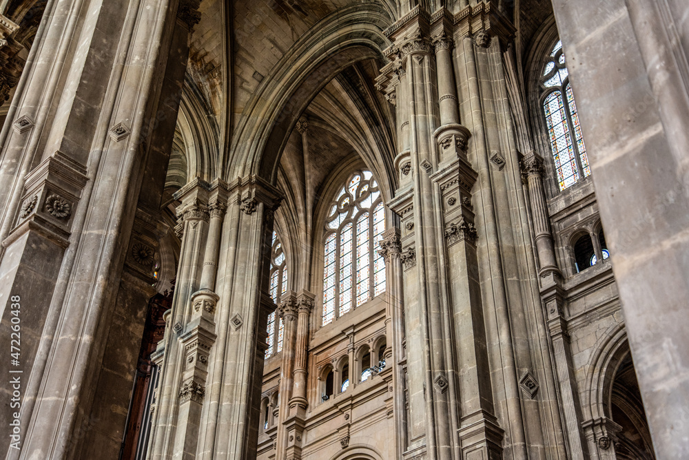 Tall columns and beautifully ornate ceiling in the gothic church Saint Eustache in Paris