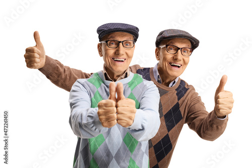 Happy elderly male twins showing thumbs up photo