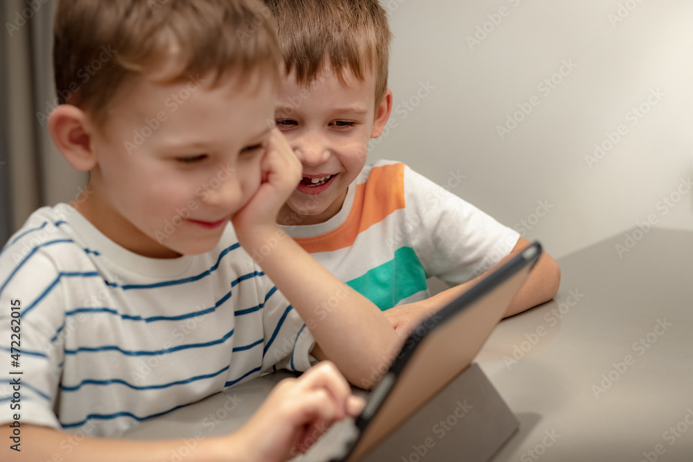 two boys play computer games at home two boys play computer games at home