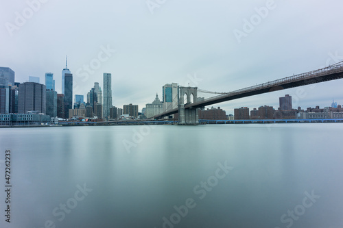 Panoramic view of New York City in Manhattan at sunrise with skyscrapers and Brooklyn Bridge
